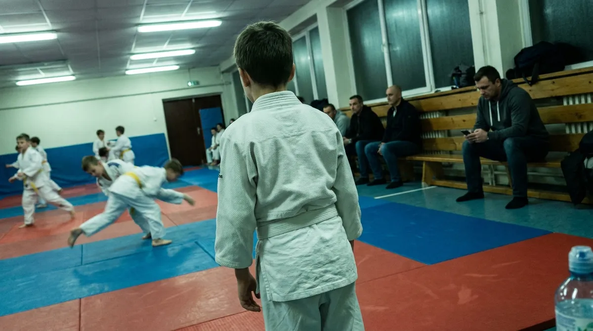 son at judo class whose $130 monthly fee is tracked in a co-parenting expense app